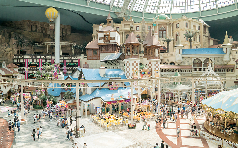 Magic Castle at Lotte World at night, glowing brightly