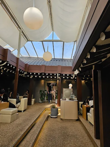 Cozy interior of Onhwa cafe in Ikseon-dong, Seoul, with traditional hanok architecture and a window view.