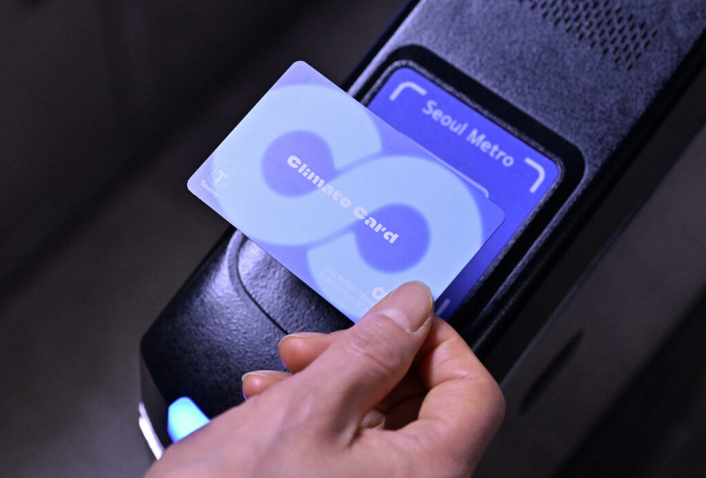 Person tapping a T-money card on a subway gate for entry or exit