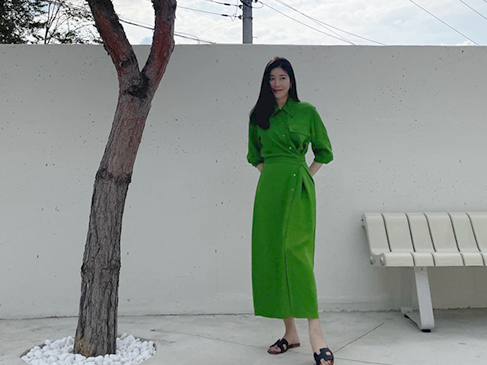 A model wearing a similar deep green shirt dress, showcasing its elegance.