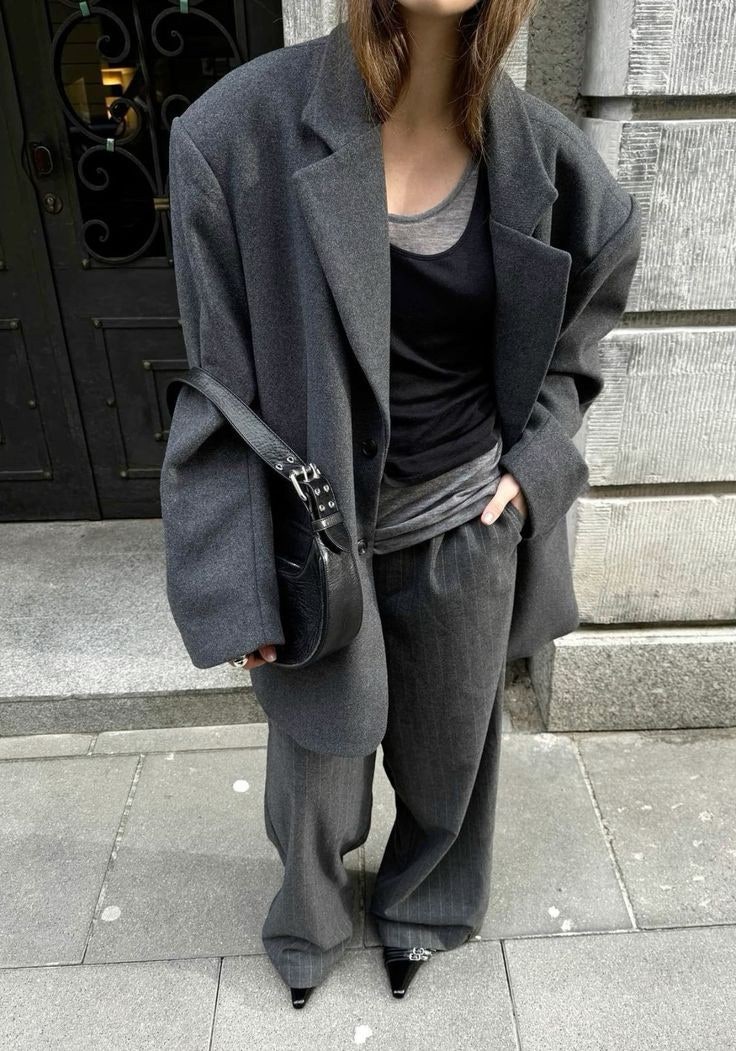 Close-up of a high-quality fabric drape on an oversized Lemaire-style coat.