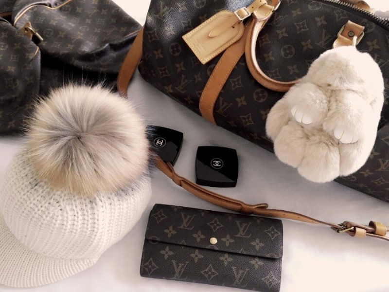 A modern street style look featuring a well-patinated Louis Vuitton Speedy bag.