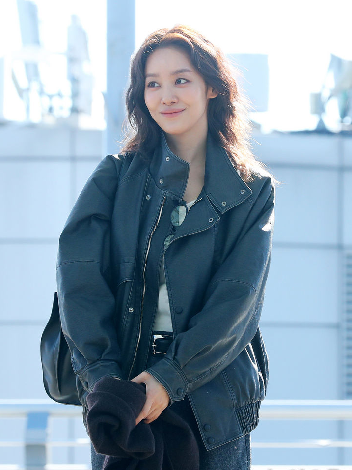 Cha Ju-young walking confidently in the bomber jacket ensemble.