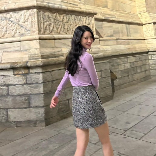 Full shot of a model wearing the grey herringbone set with a violet turtleneck.