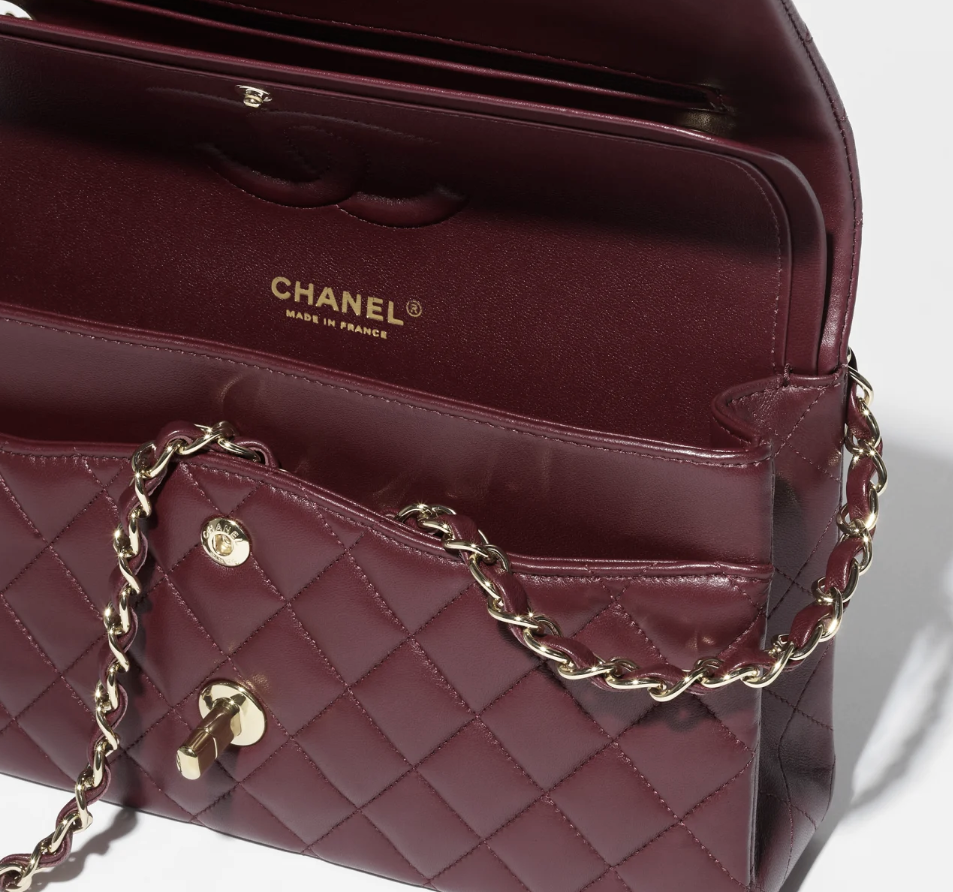 The dark burgundy Chanel 11.12 bag styled in a sophisticated, evening-appropriate look, highlighting its luxurious appeal.