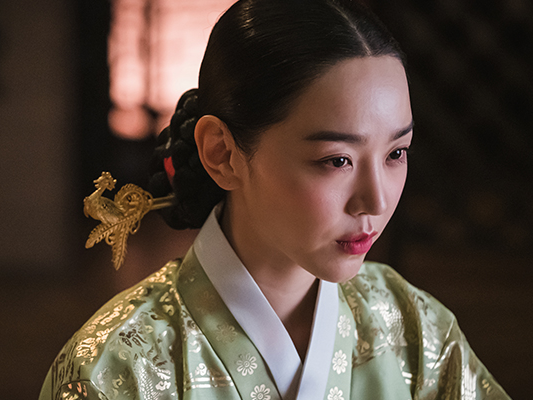 Shin Hye-sun posing with a camera, her watch visible.