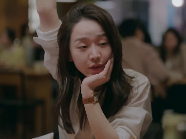 A classic Cartier watch with a brown leather strap.