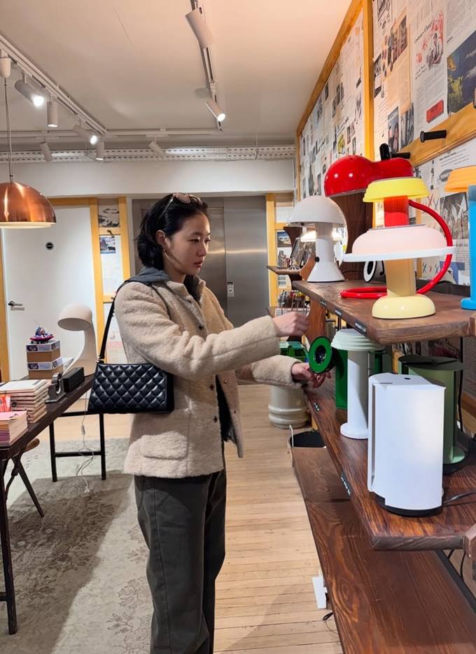 Kim Go-eun's relaxed posture and confident gaze in a Chanel ensemble.