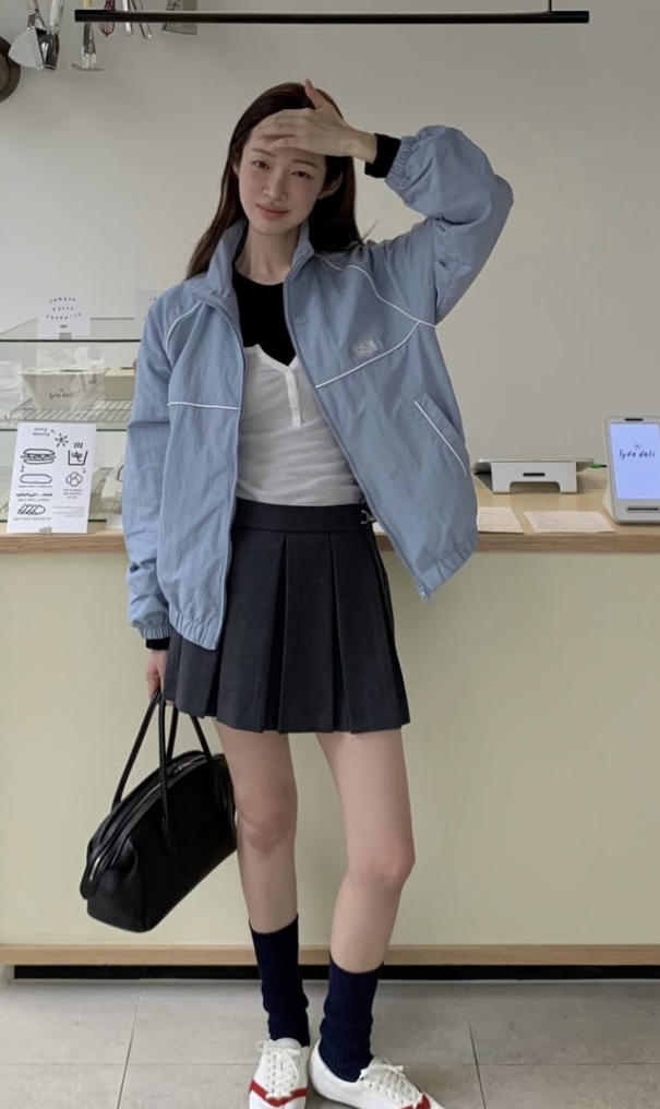 Cha Jung-won leaning against a sunlit window in a cafe setting.